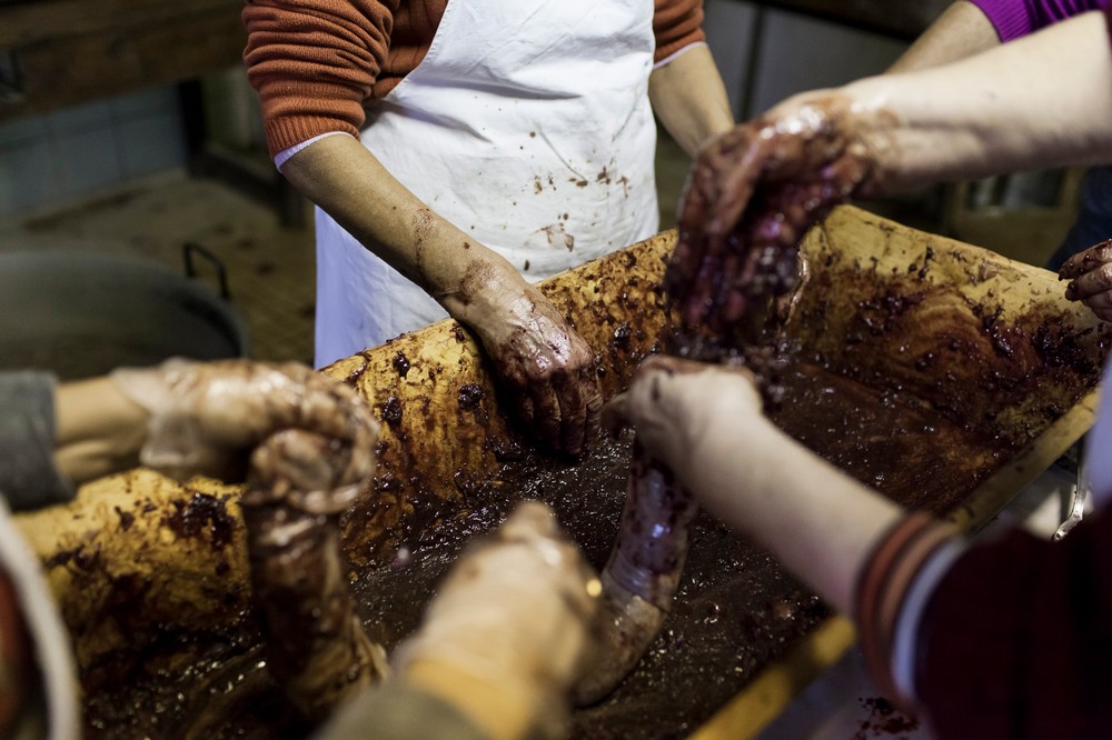 14/01/2014 - France / Aquitaine - Pour preparer les boudins il faut melanger de la viande cuite avec le sang frais de l'animal. Le tue-cochon, ou fete du cochon, est une tradition des campagnes francaises, qui correspond a l'abattage, la decoupe et la cuisine de la viande de porc. Autrefois moment important de la vie rural, cette tradition se perd aujourd'hui. Simon Lambert / Haytham Pictures 14/01/2014 - France / Aquitaine - Kill the pig - To prepare the blood sausages, cooked meat must be mixed with fresh blood. It's often the women's responsability to mix the elements. Simon Lambert / Haytham Pictures