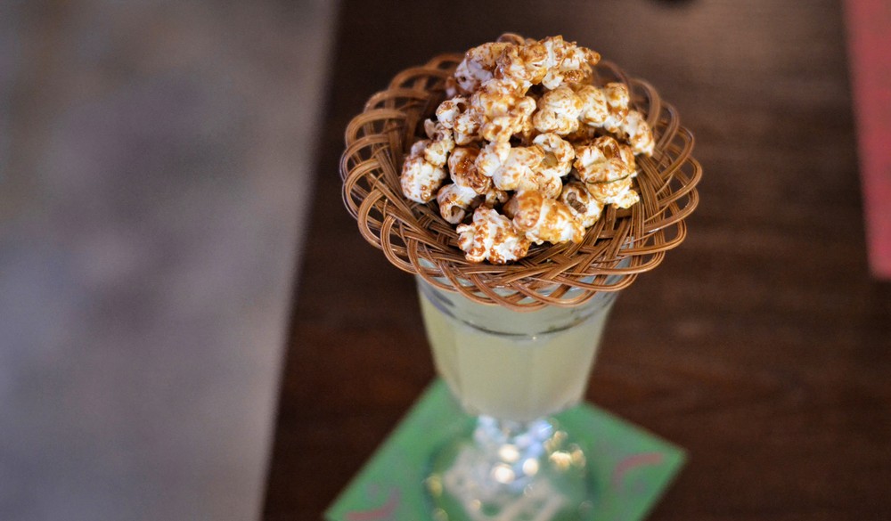 The GMtini hints at Thailand's GMO issues, serving laap-seasoned popcorn on top.