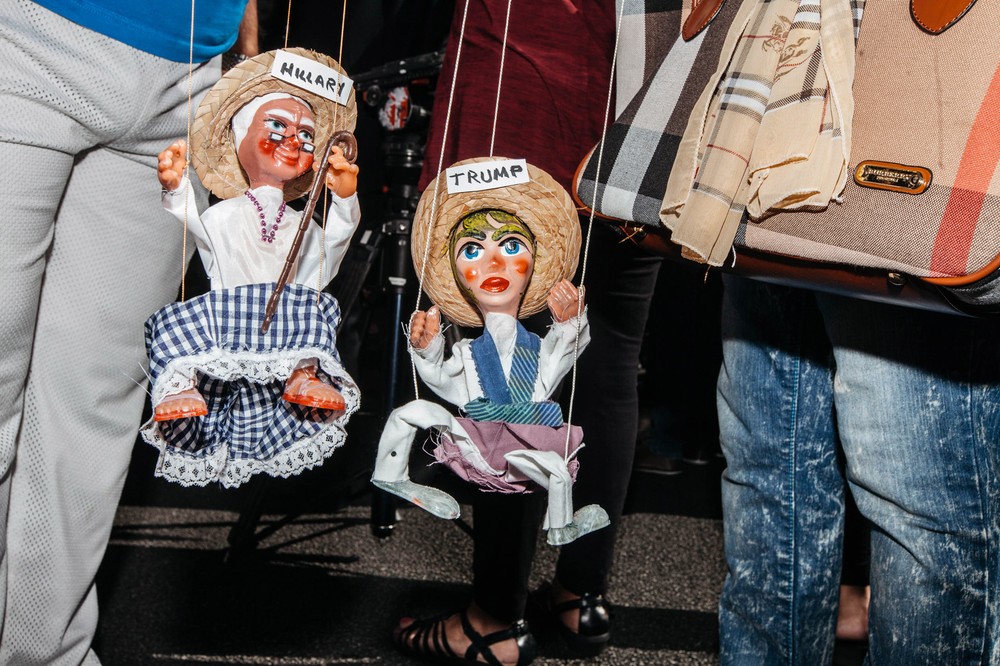 Protestors fight marionette dolls while waiting for tacos during a protest by the Culinary Union which built a 